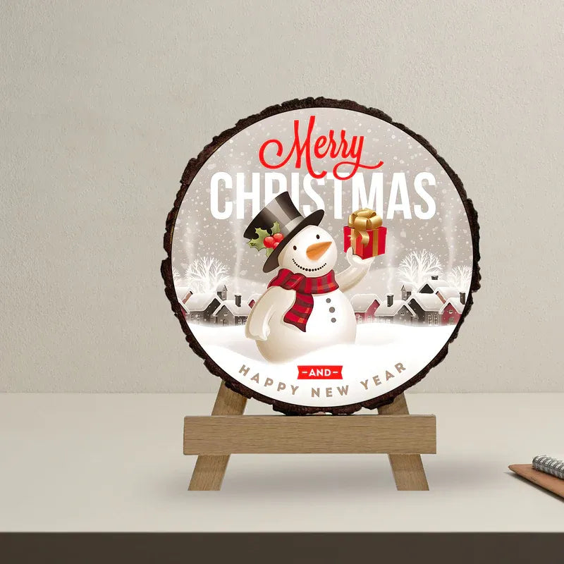 Round Christmas decoration with a snowman holding a gift, featuring 'Merry Christmas and Happy New Year' text on a wooden stand.