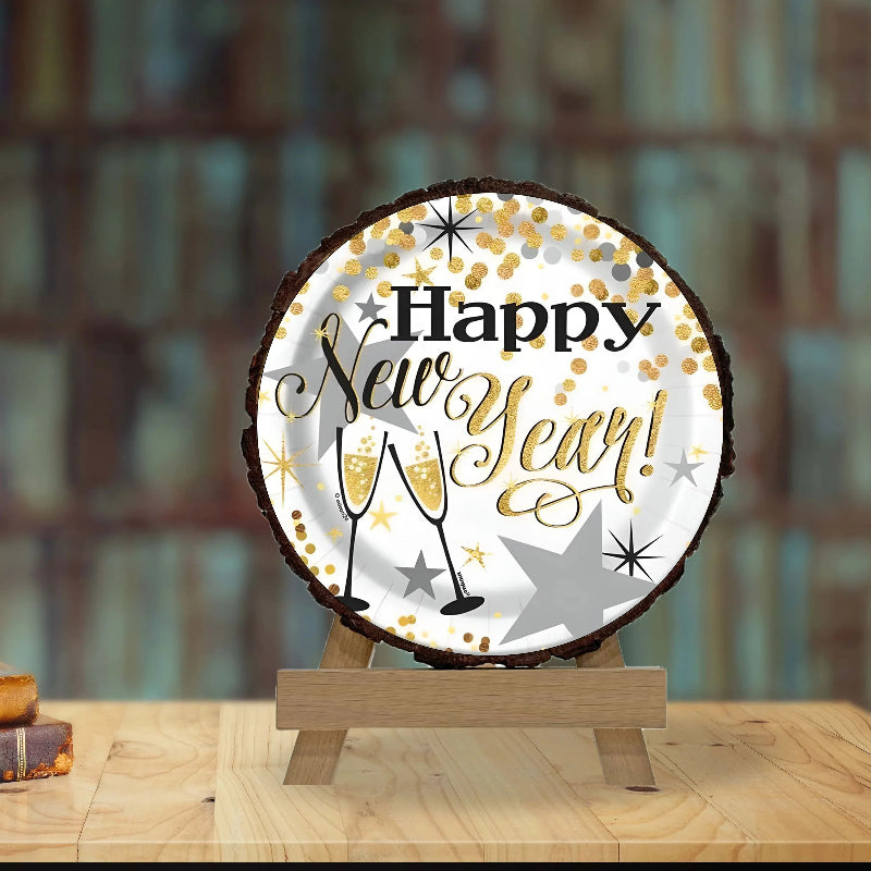 Decorative sign with 'Happy New Year!' text on a wooden stand against a blurred background