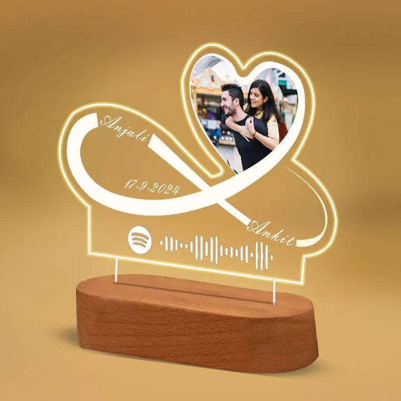Personalized lamp with heart design, names, and date on a brown background