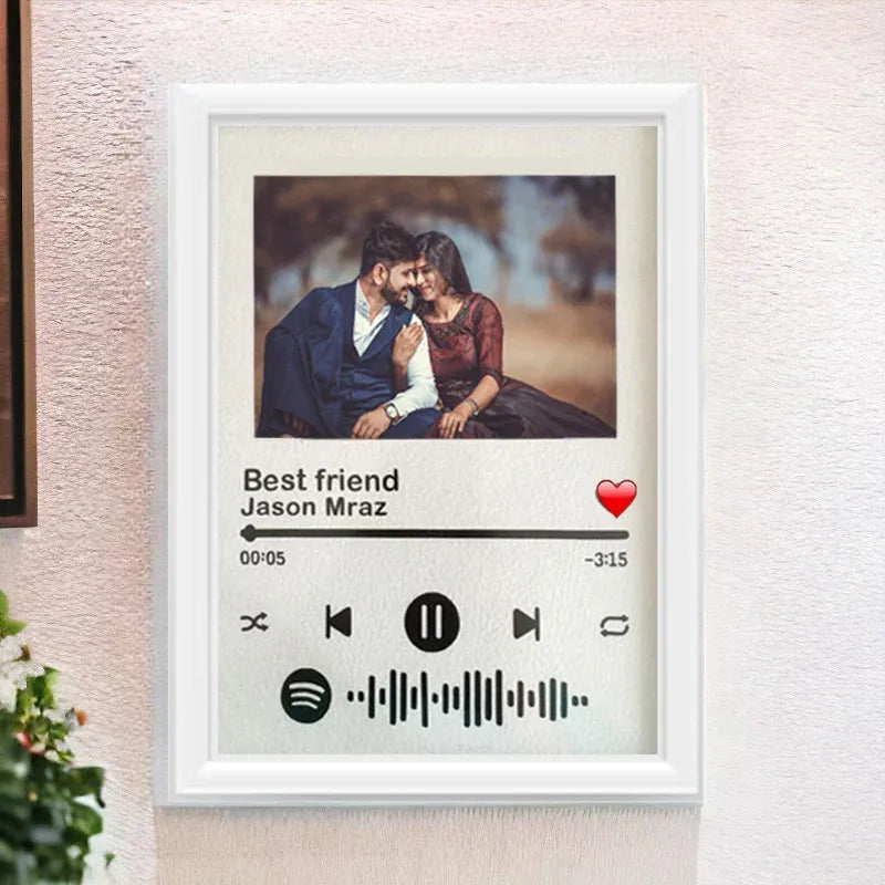 Framed artwork of a couple with a music player interface and 'Best friend' by Jason Mraz.
