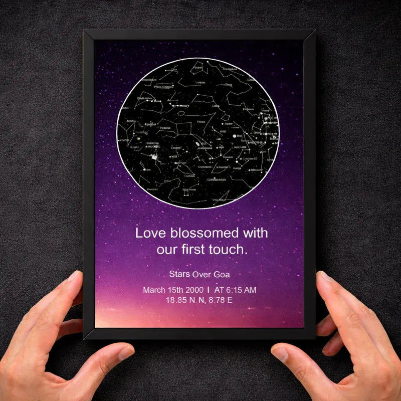 Framed star map print with personalized text against a dark background