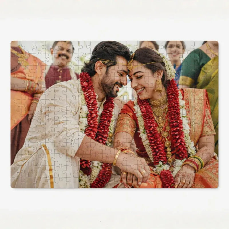 Jigsaw puzzle with a couple in traditional attire and garlands on a white background