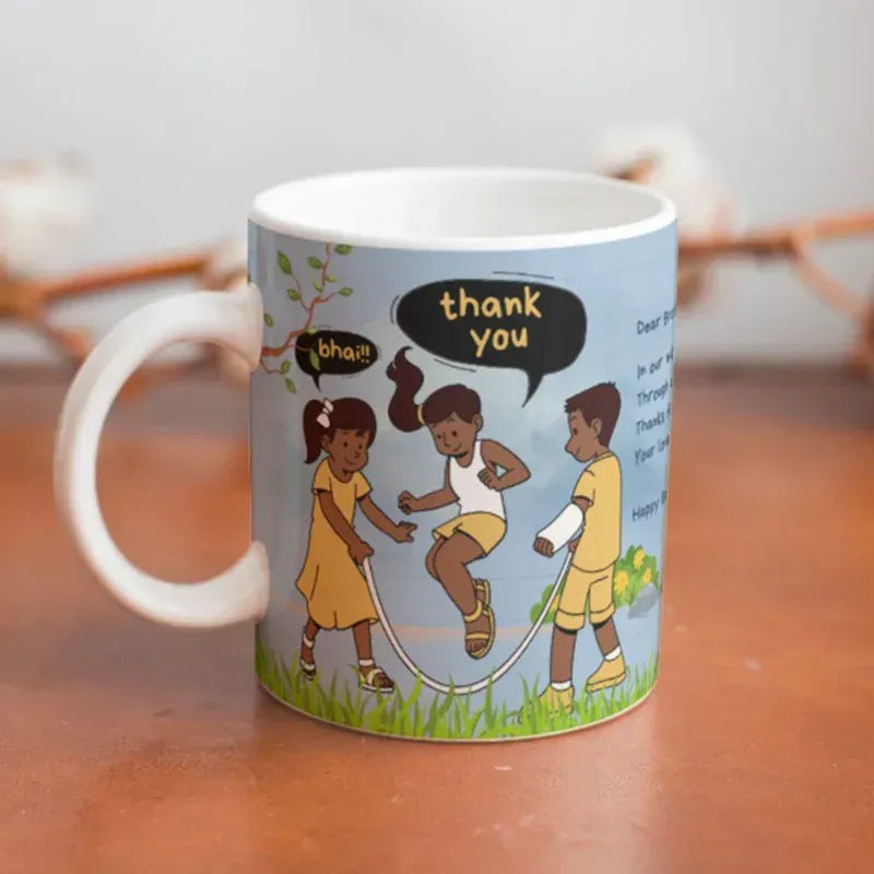 A white ceramic mug with a printed cartoon illustration of three children jumping rope, set on a wooden surface with a blurred background.