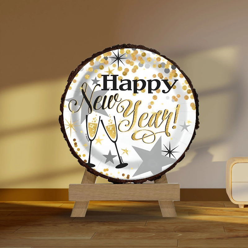 Decorative sign with 'Happy New Year!' text on a wooden stand against a beige wall.
