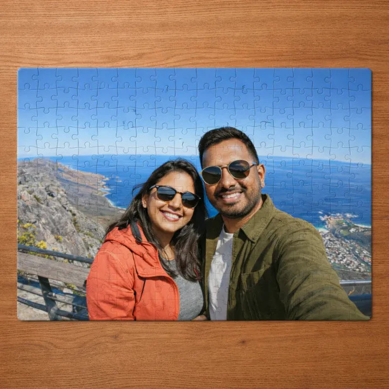 Jigsaw puzzle with a scenic background on a wooden surface