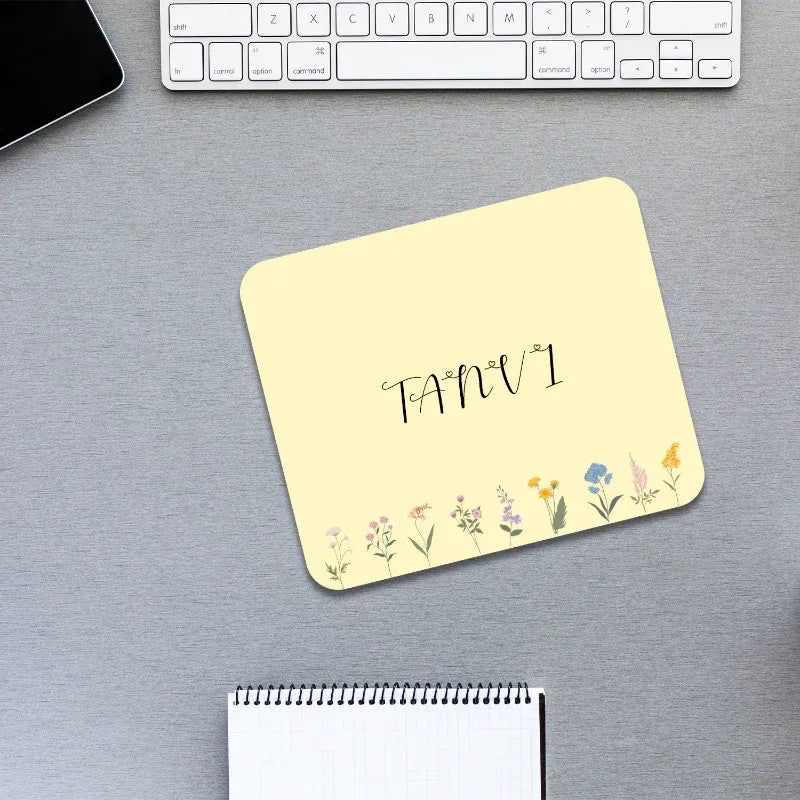 Yellow mouse pad with floral design and 'FANVI' branding on a desk.